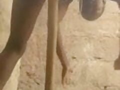 African woman masturbates with a broom handle.